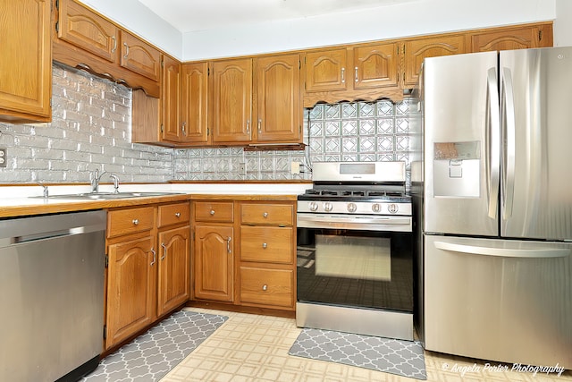 kitchen featuring tasteful backsplash, sink, and stainless steel appliances