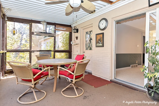 sunroom / solarium with ceiling fan