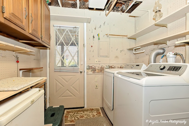 washroom with cabinets and washer and dryer