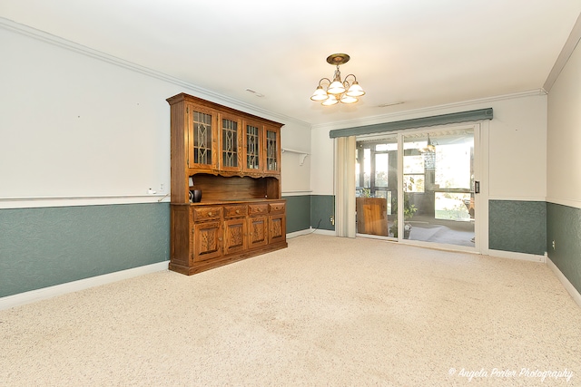 unfurnished room with a notable chandelier and ornamental molding