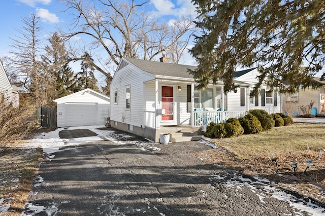 bungalow-style home with an outbuilding, covered porch, and a garage