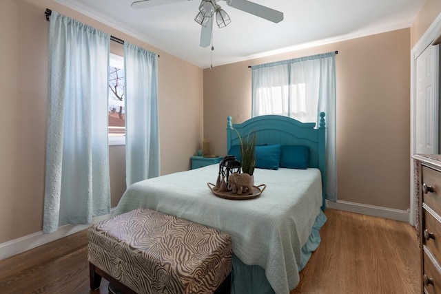 bedroom with wood-type flooring and ceiling fan