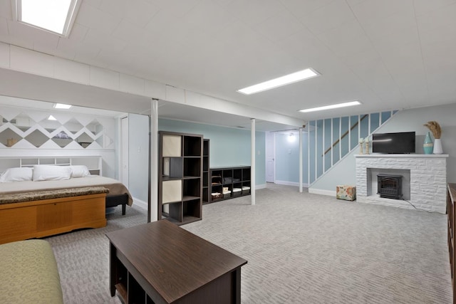 basement featuring light carpet and a wood stove