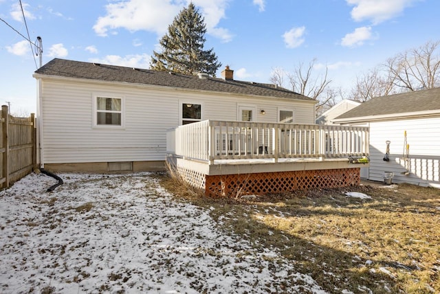 snow covered rear of property featuring a deck