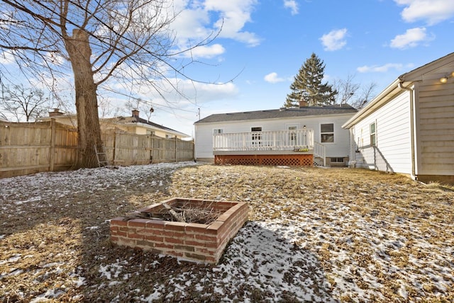 snow covered house featuring a fire pit and a wooden deck