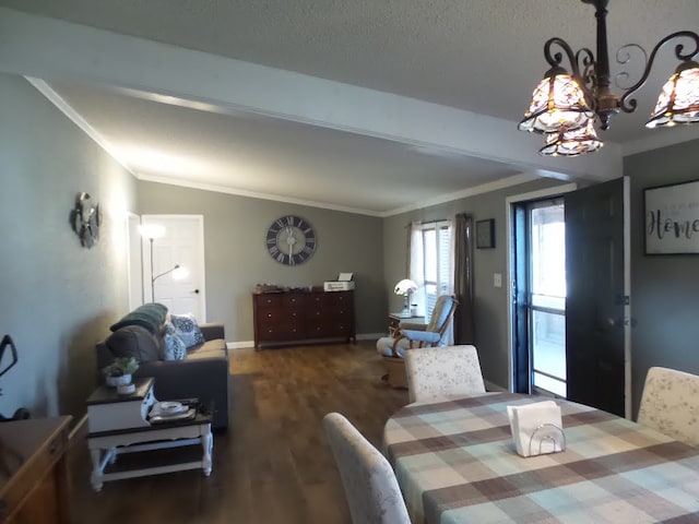 dining room with dark hardwood / wood-style floors, an inviting chandelier, lofted ceiling, and ornamental molding