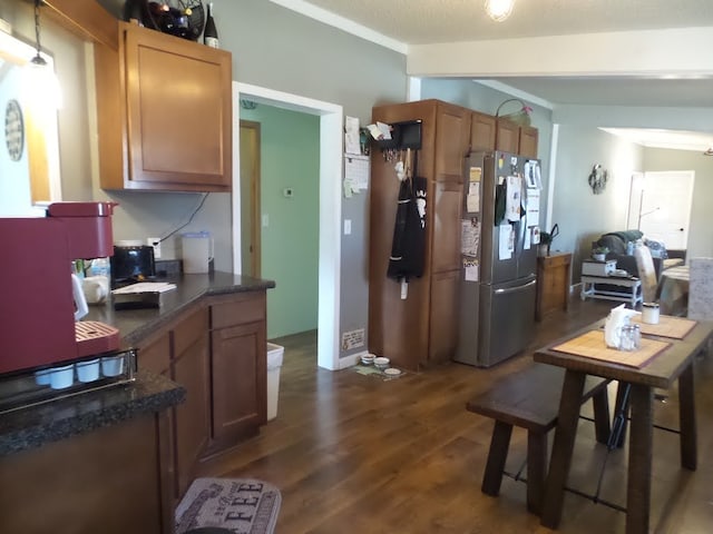 kitchen featuring dark hardwood / wood-style flooring, a textured ceiling, and stainless steel fridge