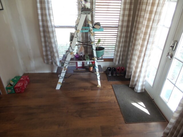 unfurnished dining area with french doors and dark wood-type flooring