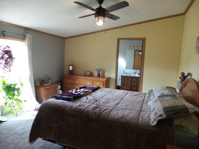 bedroom with carpet, a textured ceiling, ceiling fan, and ensuite bath