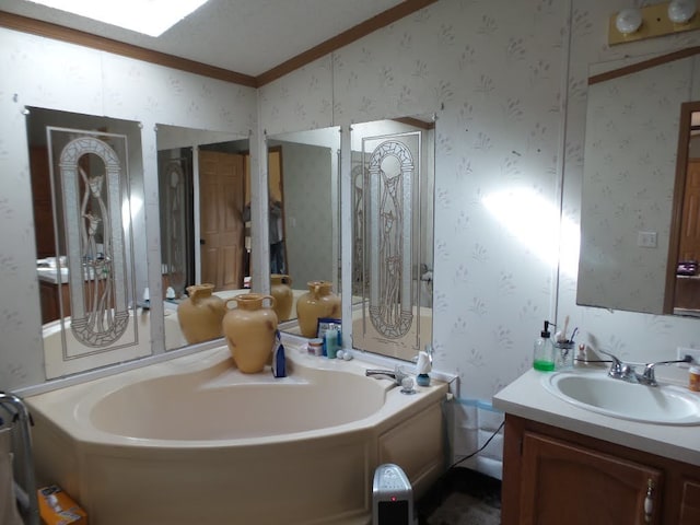 bathroom featuring vanity, a tub, and crown molding