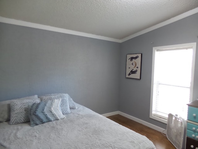 bedroom with lofted ceiling, multiple windows, crown molding, and dark wood-type flooring