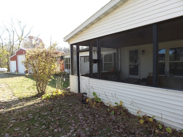 view of property exterior featuring a garage and a sunroom