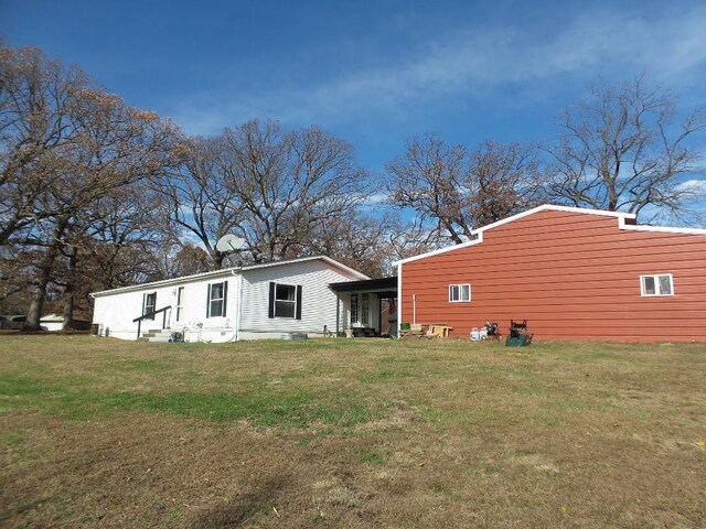 rear view of house with a yard