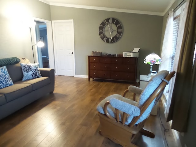 living room featuring dark hardwood / wood-style floors and crown molding