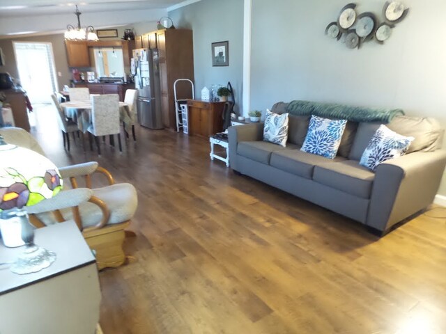 living room featuring dark hardwood / wood-style floors and a notable chandelier