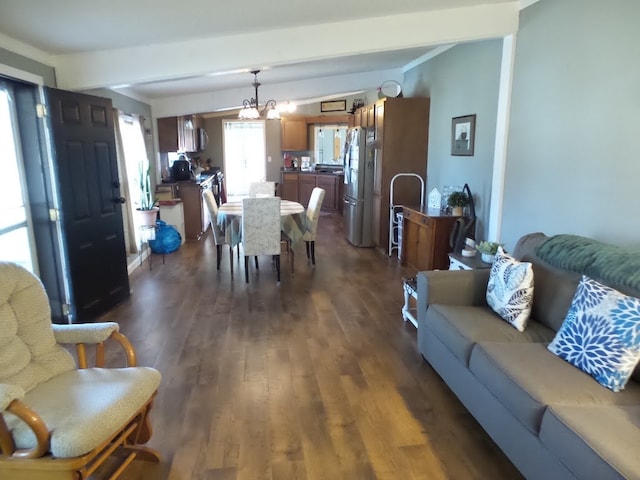 living room with dark wood-type flooring and a notable chandelier