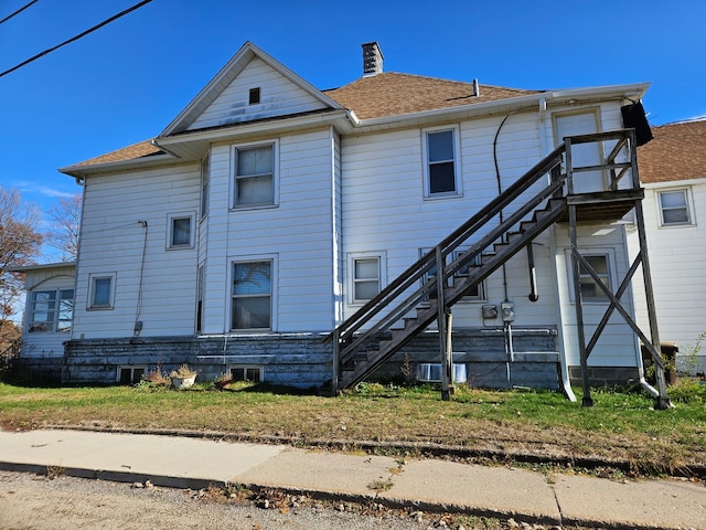 rear view of house featuring central air condition unit