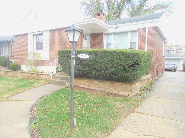 view of front of home with a garage and a front lawn