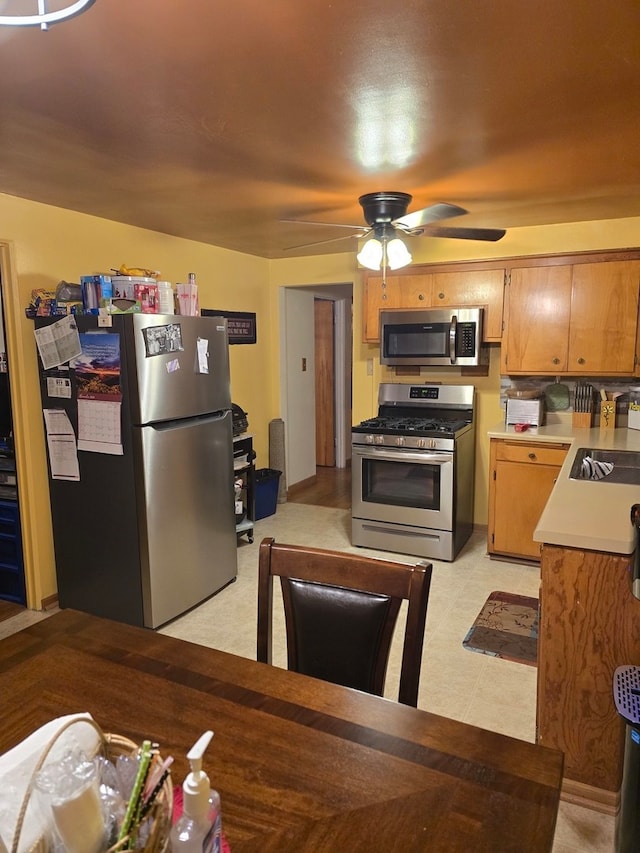 kitchen with ceiling fan and stainless steel appliances