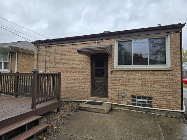 property entrance featuring a patio and a deck