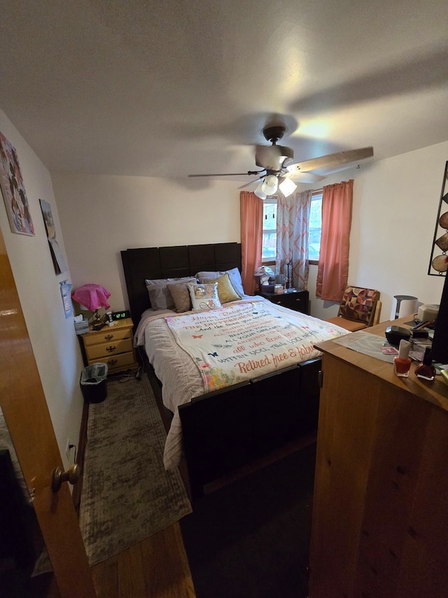 bedroom with wood-type flooring and ceiling fan