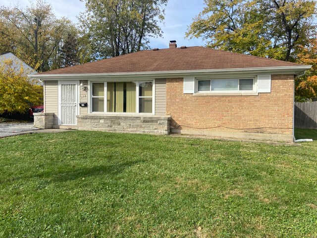 rear view of house featuring a yard