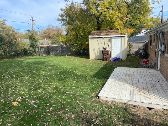 view of yard featuring a deck and a shed