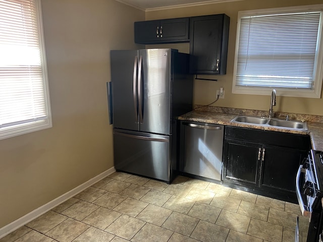 kitchen featuring ornamental molding, a wealth of natural light, appliances with stainless steel finishes, and sink