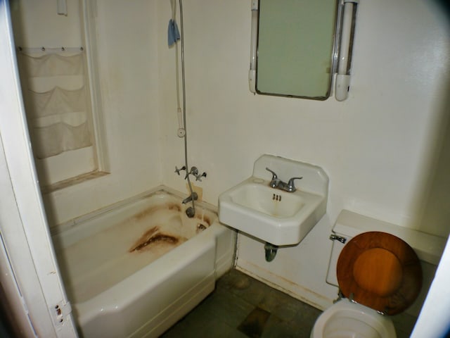 full bathroom featuring toilet, washtub / shower combination, sink, and tile patterned flooring