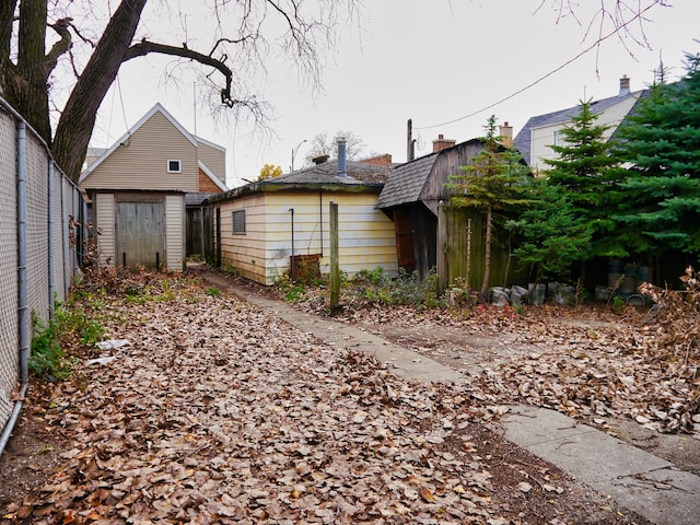 view of side of home with a storage unit