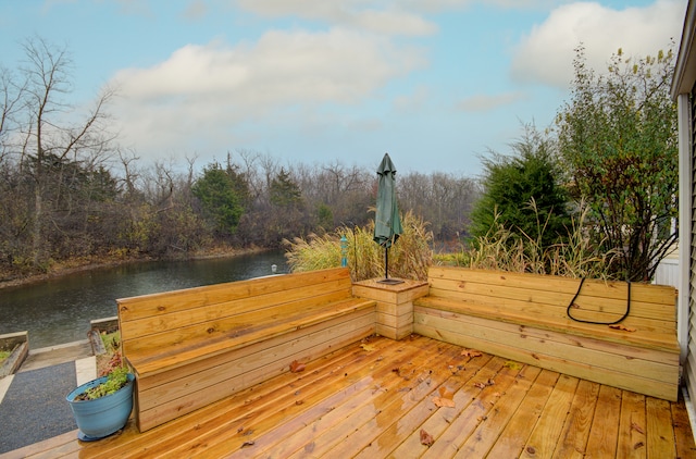 wooden deck featuring a water view