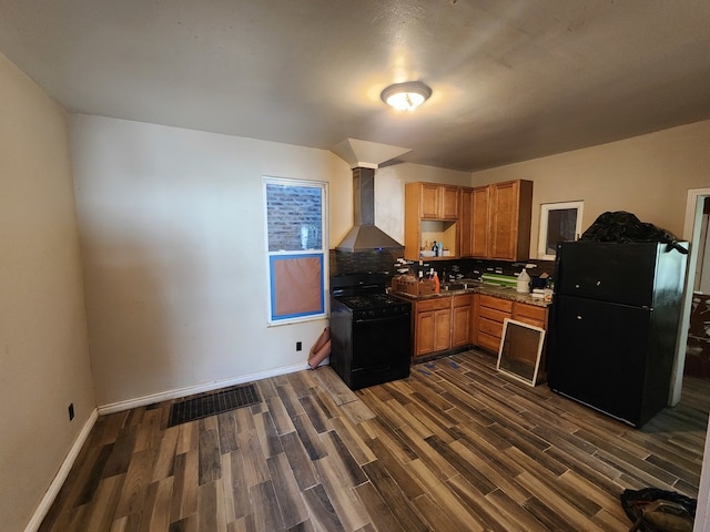 kitchen featuring wall chimney exhaust hood, dark hardwood / wood-style floors, black appliances, and decorative backsplash