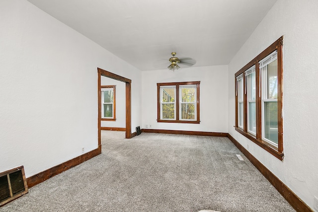 carpeted empty room featuring ceiling fan