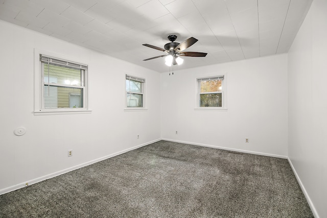 empty room featuring carpet flooring, a wealth of natural light, and ceiling fan