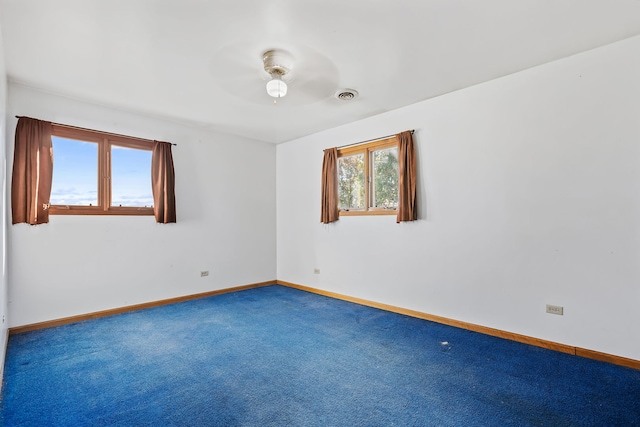 spare room with carpet floors and ceiling fan