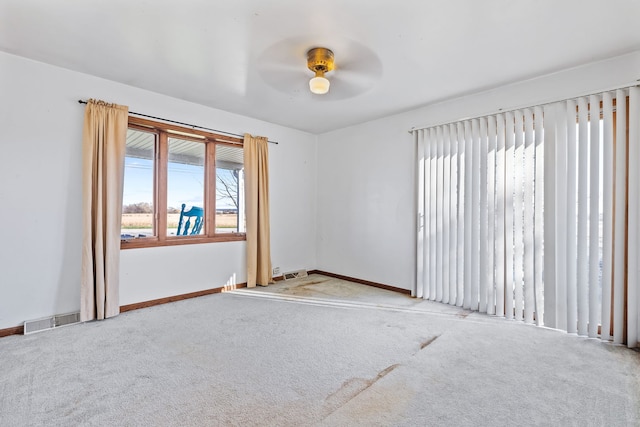 empty room with light colored carpet and ceiling fan