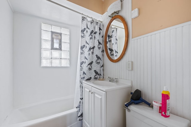 full bathroom featuring toilet, vanity, and shower / bath combo with shower curtain