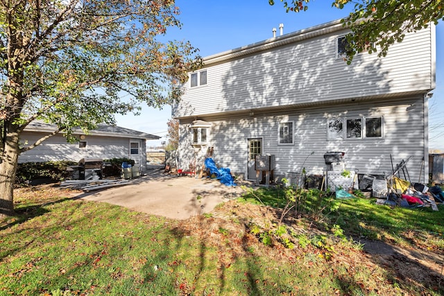 back of property with a patio and a lawn