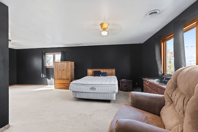 bedroom with light colored carpet and ceiling fan