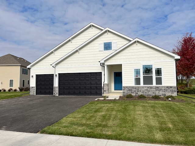 craftsman-style house featuring a garage and a front yard