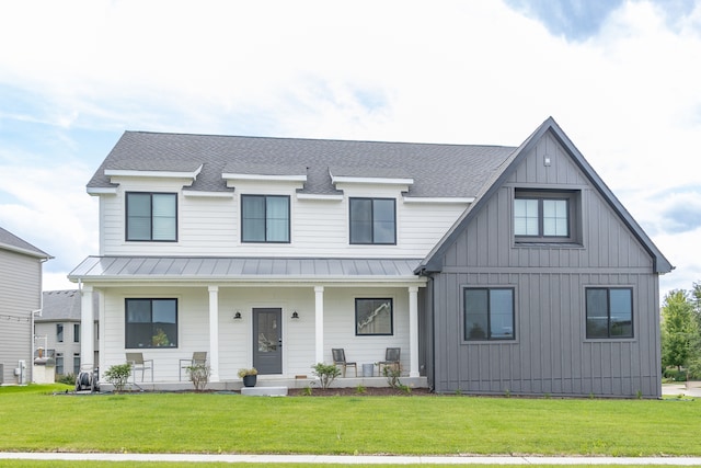 modern farmhouse with a front yard and a porch