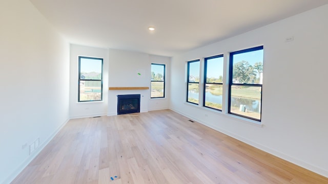 unfurnished living room featuring light wood-type flooring