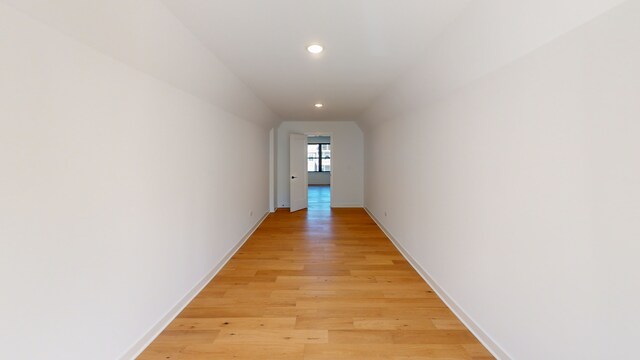 hallway with light hardwood / wood-style floors