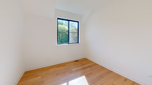 unfurnished room with light wood-type flooring