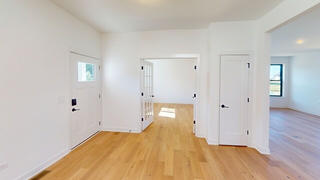 hallway with light hardwood / wood-style flooring