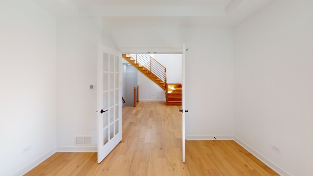 additional living space with wood-type flooring and french doors