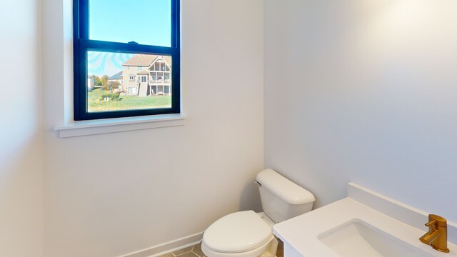 bathroom with toilet and tile patterned flooring