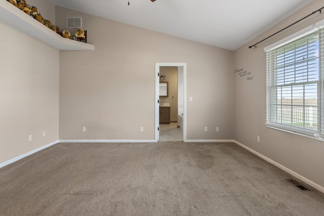 carpeted empty room with ceiling fan and vaulted ceiling