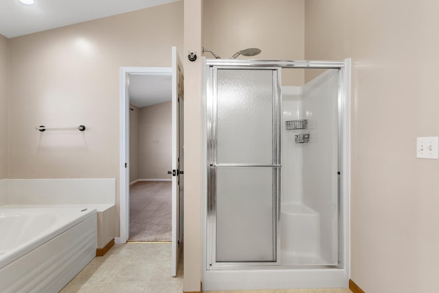 bathroom featuring tile patterned flooring, shower with separate bathtub, and vaulted ceiling