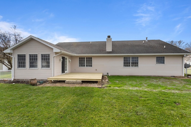 back of property with a wooden deck and a yard